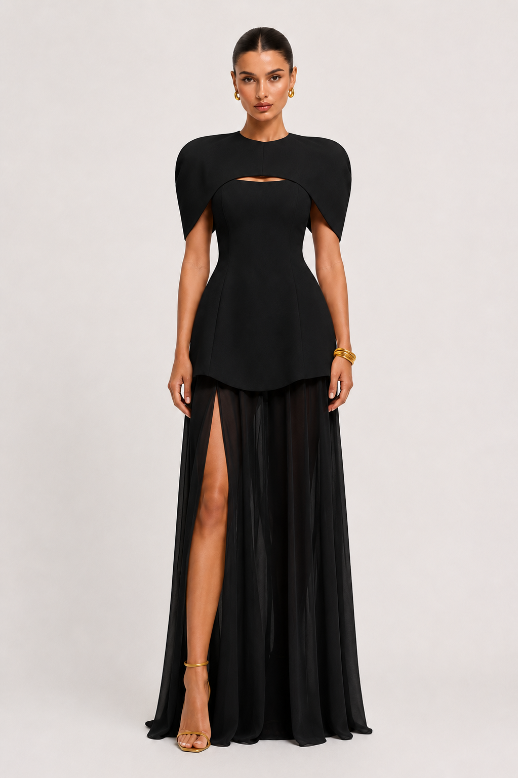 Black evening gown with cut-out design and high slit on a white background